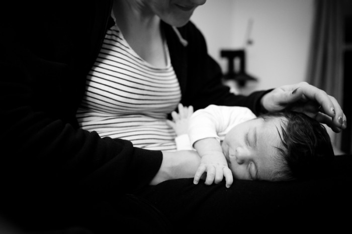 Documentary style photograph of newborn baby and Mum