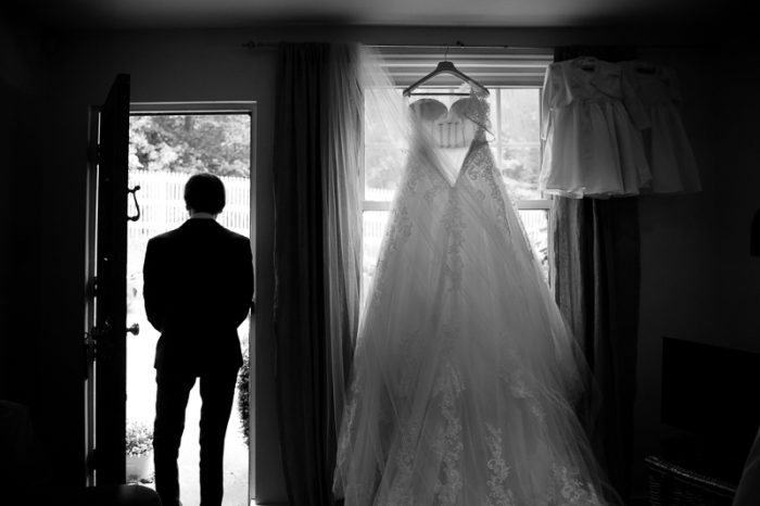 Black and white photo of father of the bride and wedding dress