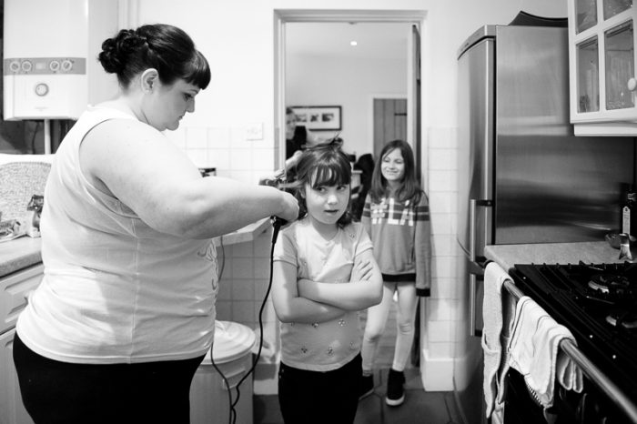 Black and white photo of flower girl getting ready for the big day