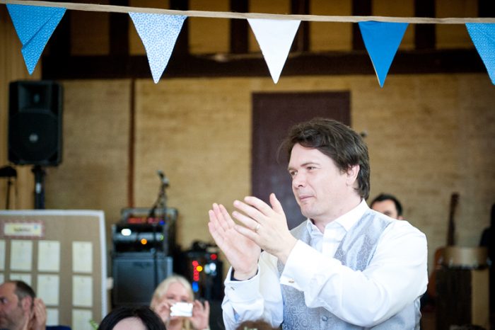 Guest appreciating the speeches at village hall wedding