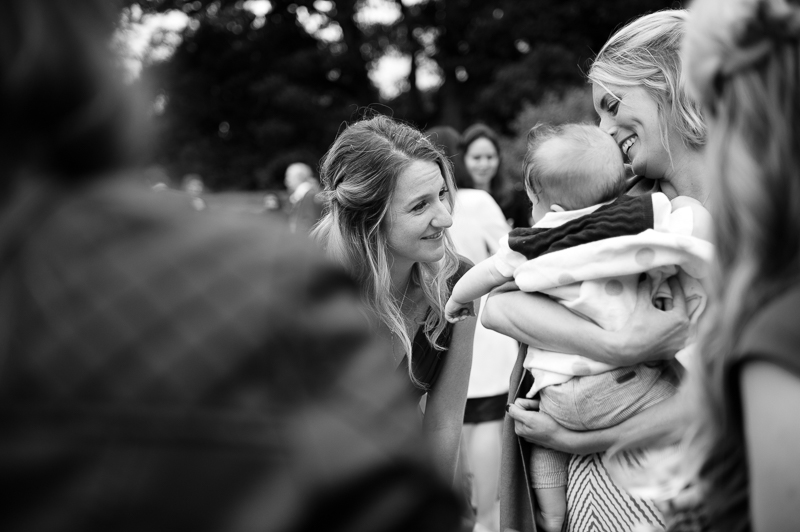 Bridesmaid greeting baby at Ridge Farm wedding